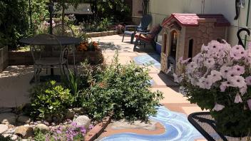Tucker Backyard after renovation with tiling, plants and painted pathway