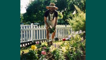 Photo of a young Kent Bradford planting in his garden.