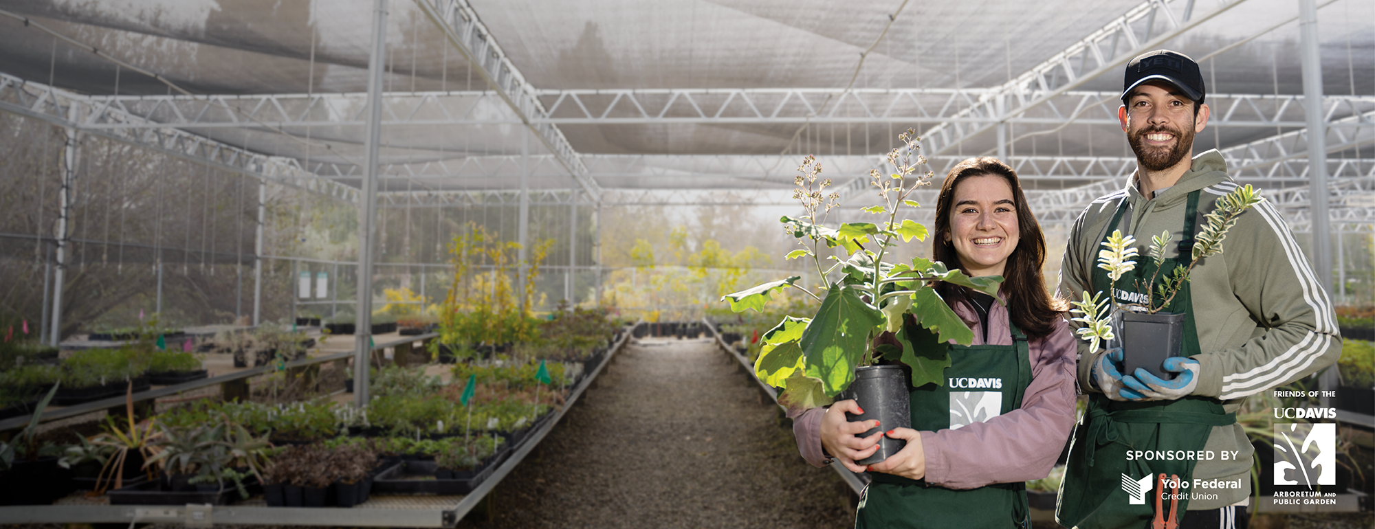 Image of UC Davis students wearing great aprons and holding plants in the Arboretum Teaching Nursery.