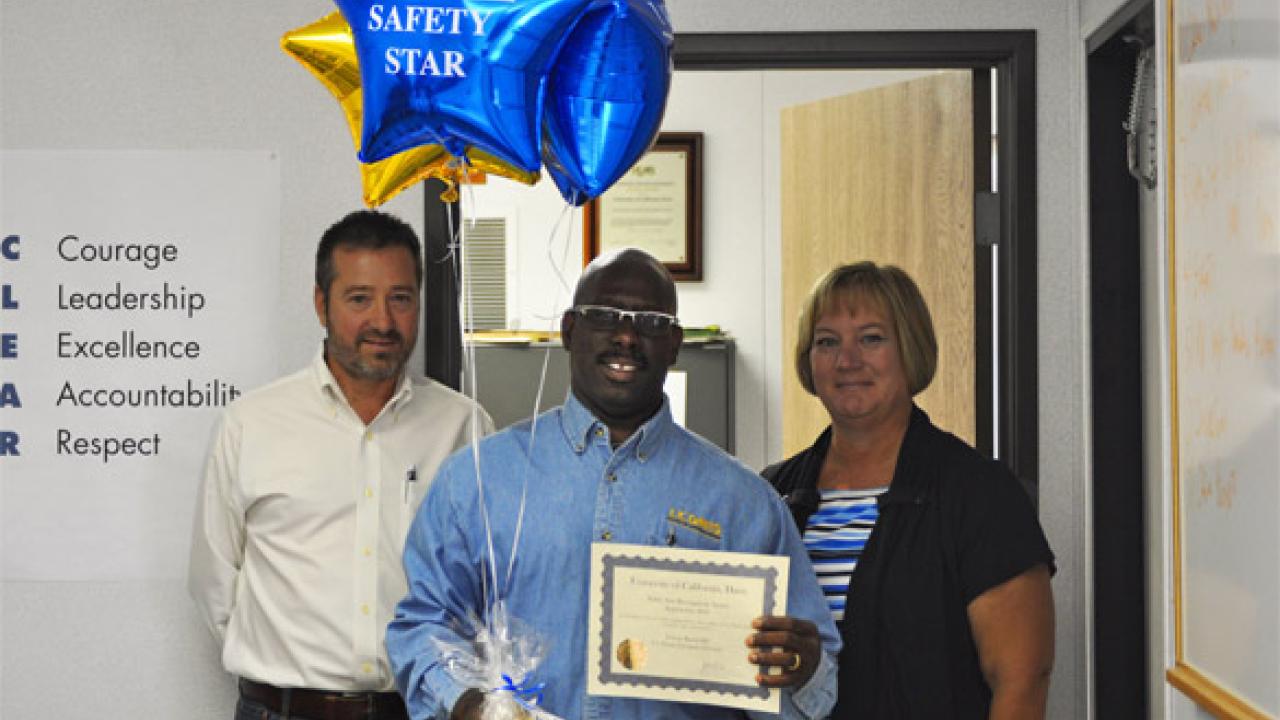 Nelson Randolph shows off his Safety Star Award with Grounds & Landscape Services Superintendent Cary Avery and Kim Rhodes, Director of Budget and Planning for CPCR. Nelson Randolph