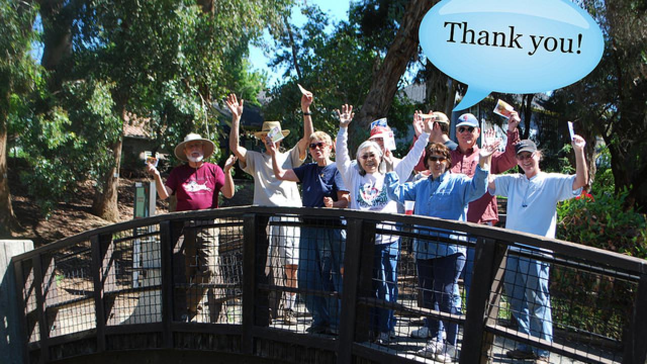 volunteers and staff with thank you speech bubble