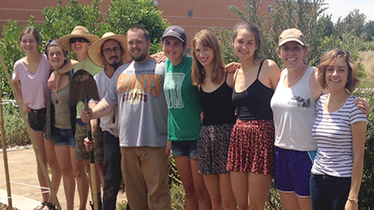 Carli Hambly (second form left) and Natalie Dean (fourth from right) will lead this year’s edible landscape interns in a food gleaning pilot project. Here Carli and Natalie are pictured with our 2013-14 edible landscape interns. Edible landscape interns pilot campus gleaning projects
