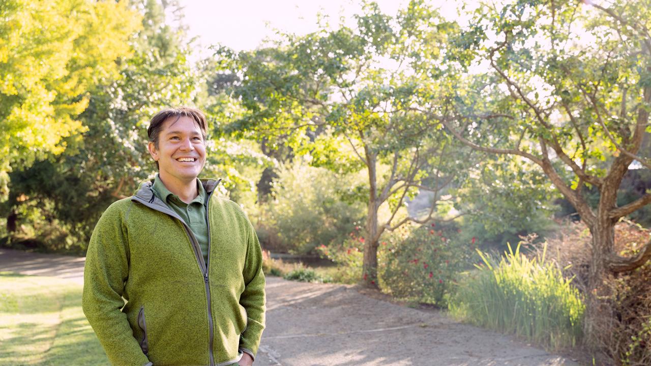 Image of Tyler Kern, UC Davis' first campus forester, in the Arboretum.