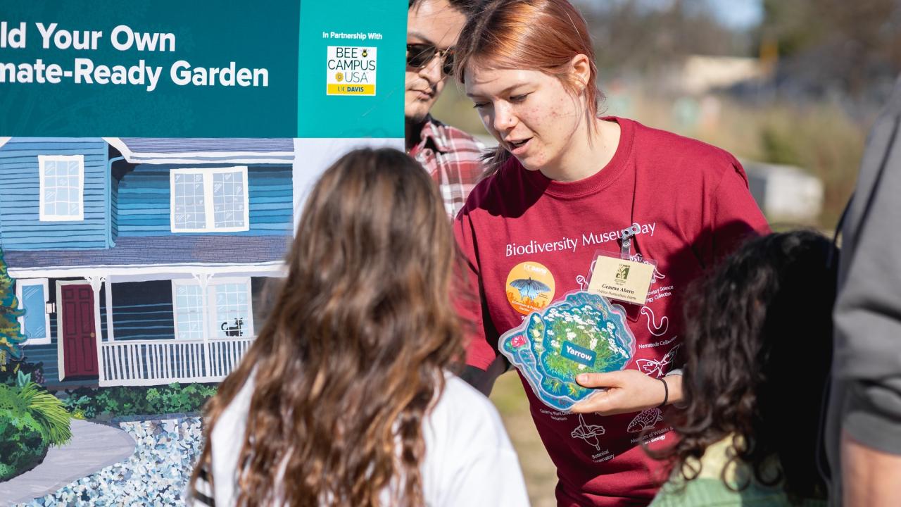Visitors gather around the interactive "Build Your Own Climate-Ready Garden" activity at Biodiversity Museum Day