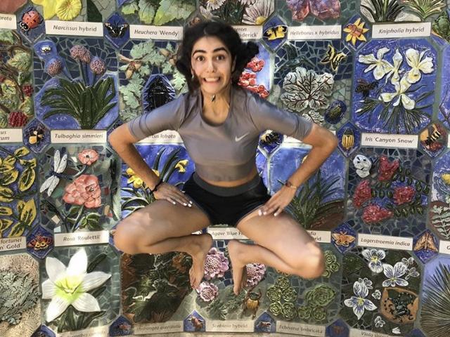 Image of Anita Shahriary jumping at UC Davis Nature's Gallery Court.