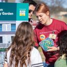 Visitors gather around the interactive "Build Your Own Climate-Ready Garden" activity at Biodiversity Museum Day