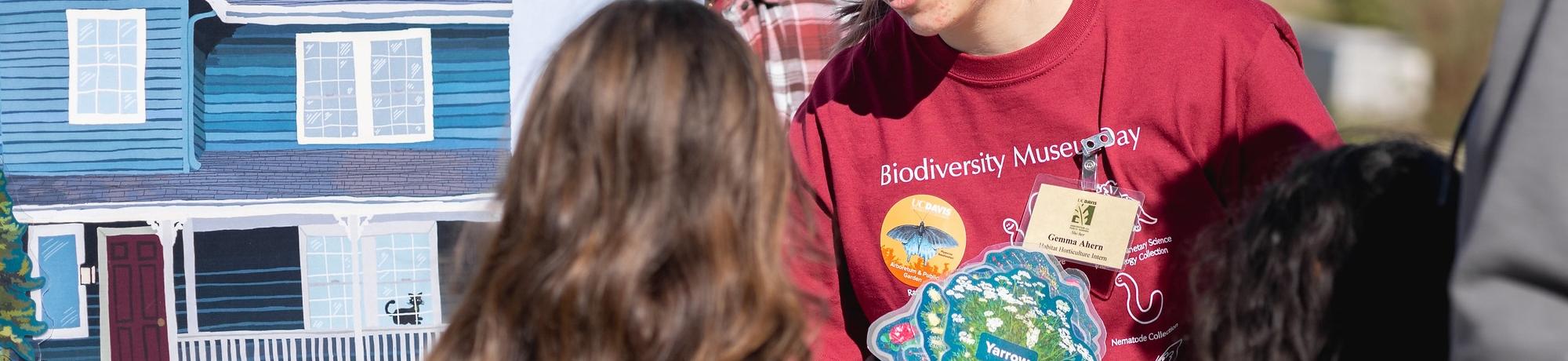 Visitors gather around the interactive "Build Your Own Climate-Ready Garden" activity at Biodiversity Museum Day