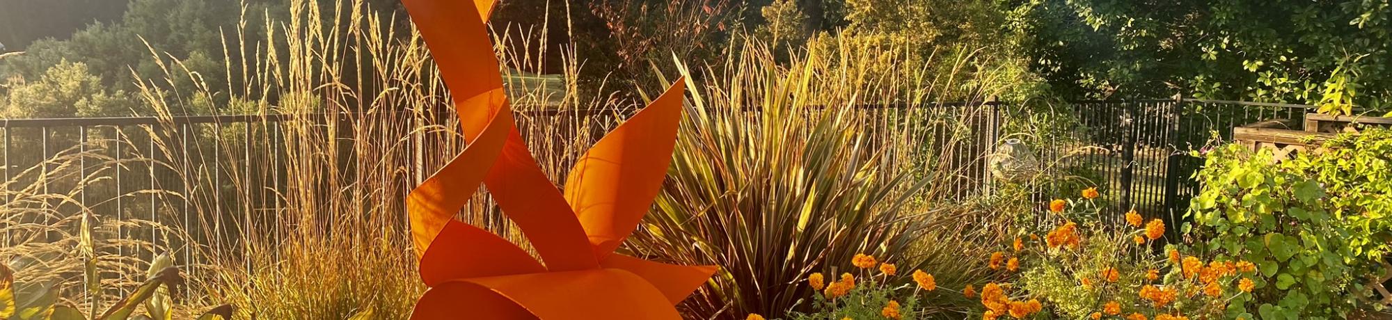 Sculpture among yellow and orange flowers